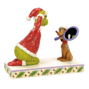 max holding a mirror for the grinch figurine